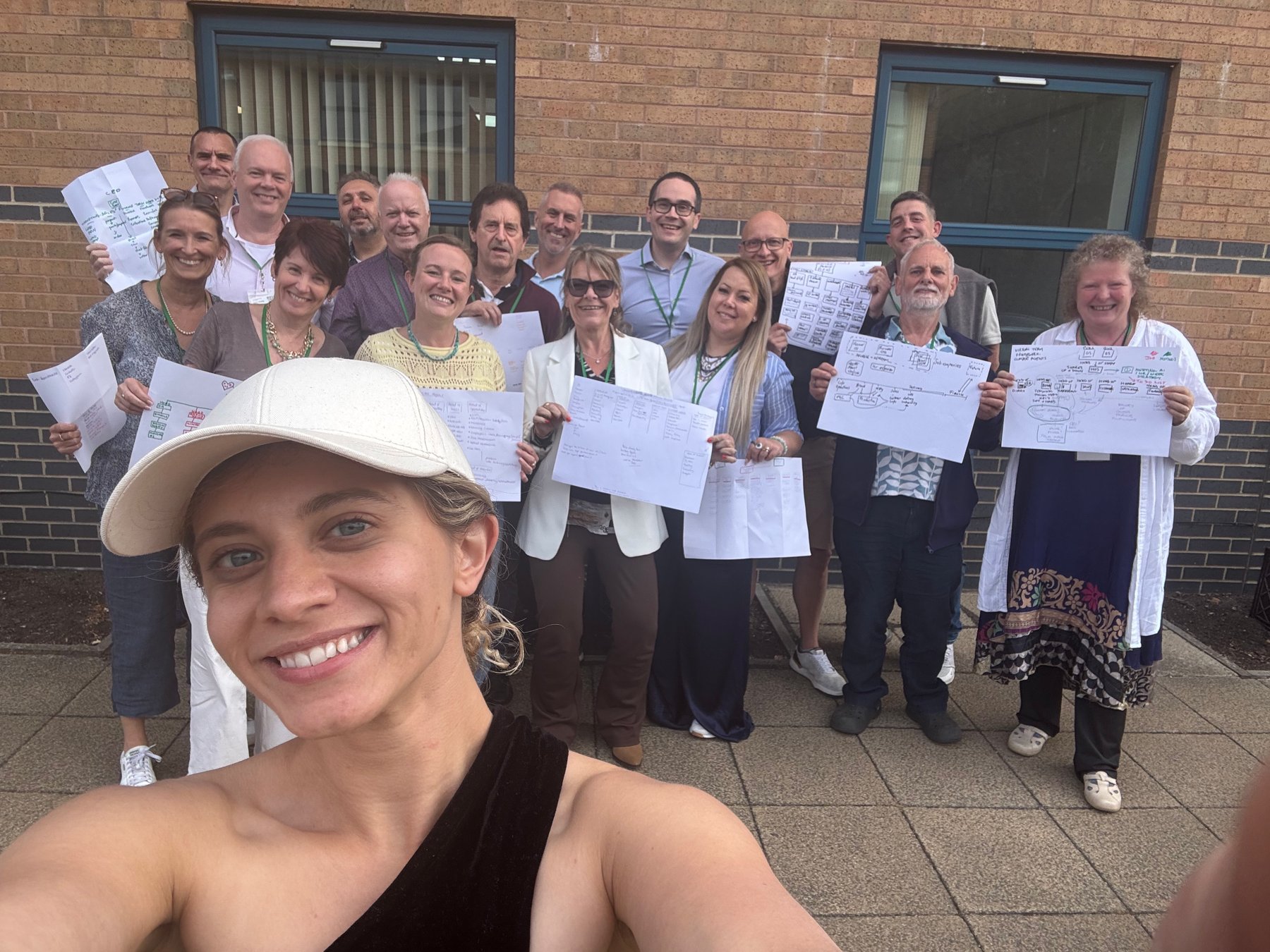 Sabrina with an AI Profits room in Peterborough, delegates holding signs